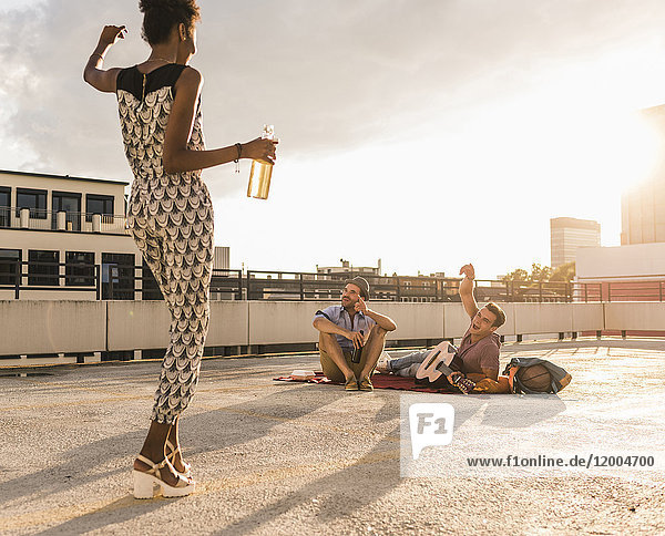 Young woman dancing on a rooftop party
