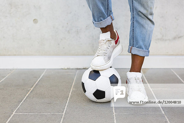 Man's feet with soccer ball
