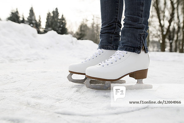 Feet of woman wearing ice skates