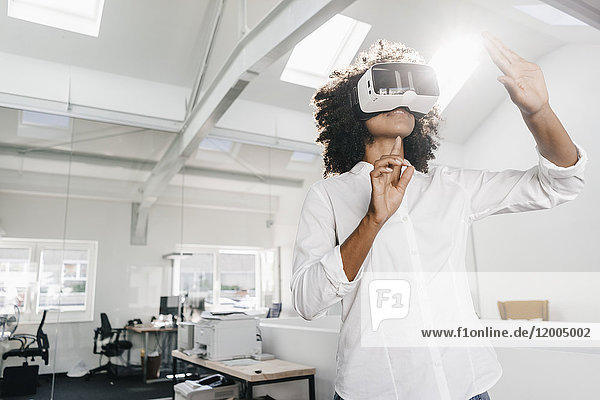 Woman wearing VR glasses in office