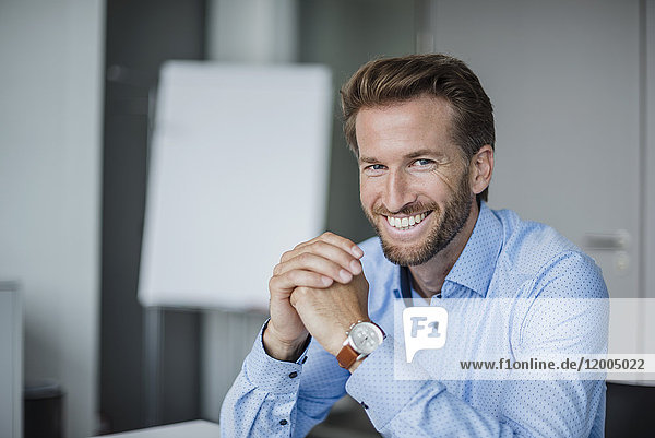 Portrait of laughing businessman in the office