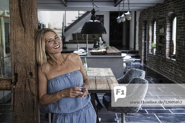Woman standing in her comfortable country house  smiling