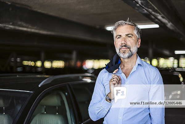 Portrait of businessman in parking garage