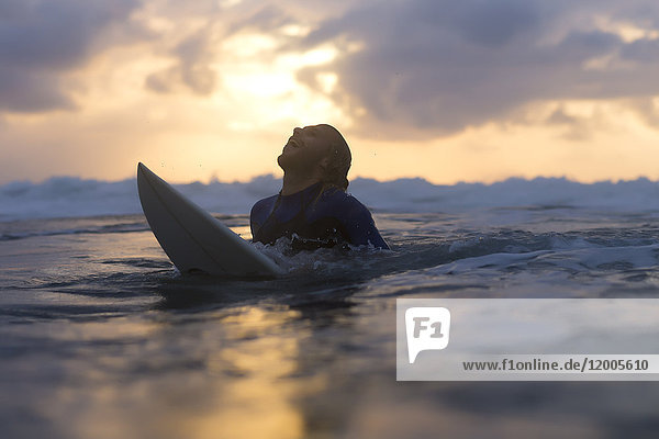 Indonesia  Bali  surfer in the ocean at sunrise