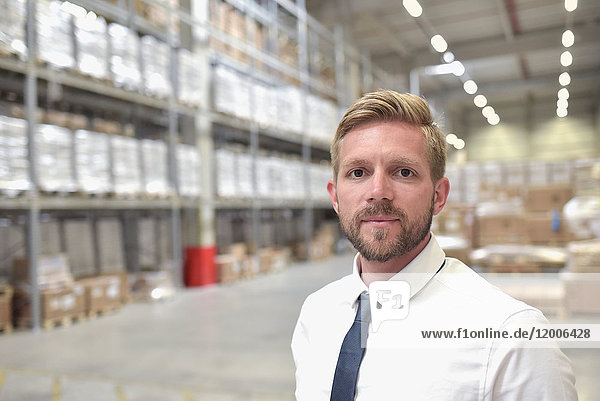 Portrait of confident businessman in warehouse
