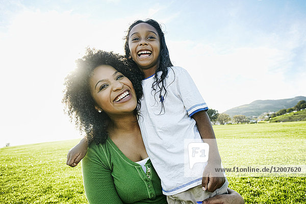 Portrait of smiling mother and mixed race daughter