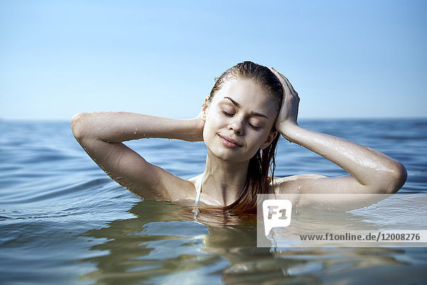 Caucasian woman relaxing in ocean