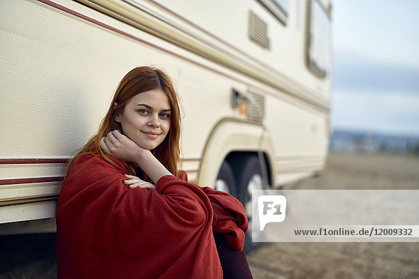 Caucasian woman leaning on motor home