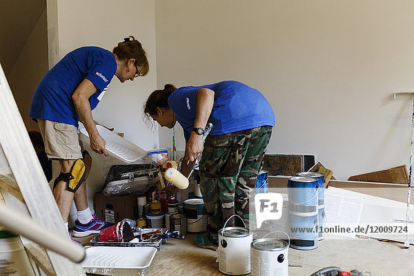 Women preparing to paint walls