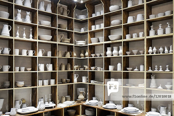 White ceramic pottery on shelves in store