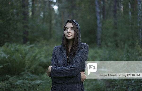 Kalte kaukasische Frau im Wald stehend