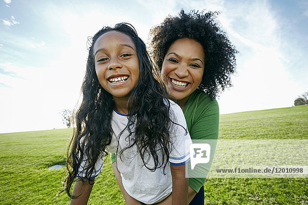 Portrait of smiling mixed raced mother and daughter