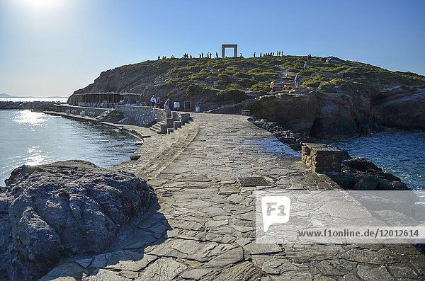 Ocean promenade on the island of Naxos  Greece with Portara  a 2 500-year-old marble doorway  in the distance.