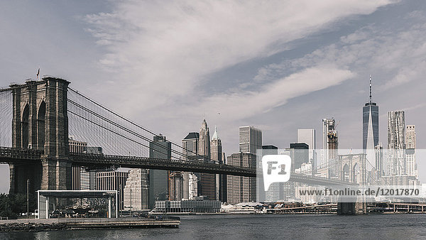 Brooklyn Bridge Over East River against Manhattan skyline  New York City  New York  USA