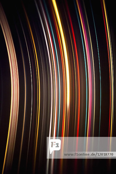 Abstract image of colorful light trails against black background