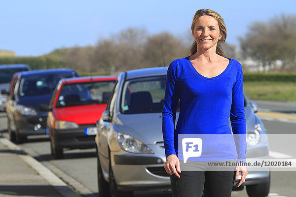 France woman in front of her car.