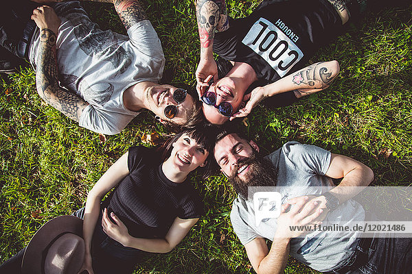 Portraits of a group of young Hipster lying in the grass