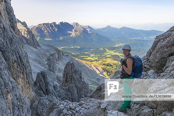 Hiker on the Santner via ferrata  panoramic view of the Latemar Group  Rosengarten Group  Dolomites  South Tyrol  Trentino-Alto Adige  Italy  Europe