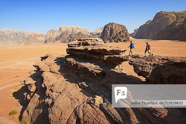 Couple hiking at Rock Arch  Al Borg Alsagheer  Wadi Rum  Jordan  Asia