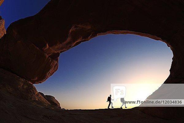 Couple hiking at Rock-Arch Al Kharza  Wadi Rum  Jordan  Asia