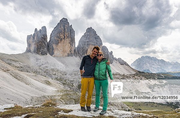 Two hikers in front of the northern walls of the Three Peaks  Sesto Dolomites  South Tyrol  Trentino-South Tyrol  Alto-Adige  Italy  Europe