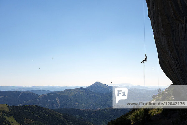 A climber ascends a rope on the cliffs of Ceuse  a mountain in the Alpes Maritimes  Haute Alpes  France  Europe