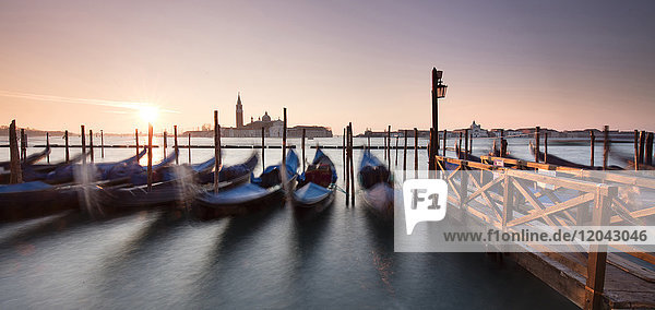 View towards San Giorgio Maggiore at dawn from Riva Degli Schiavoni with gondolas in foreground Venice UNESCO World Heritage Site Veneto Italy Europe