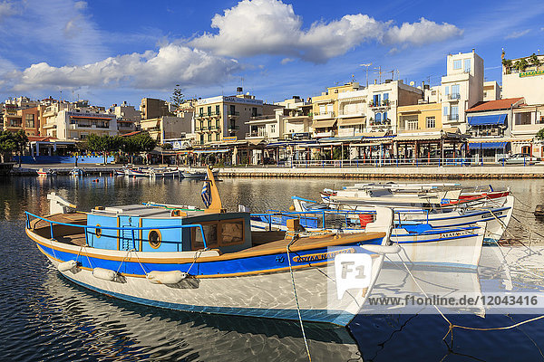 Small fishing boats reflected in Voulismeni Lake  Agios Nikolaos  Lasithi  Crete  Greek Islands  Greece  Europe