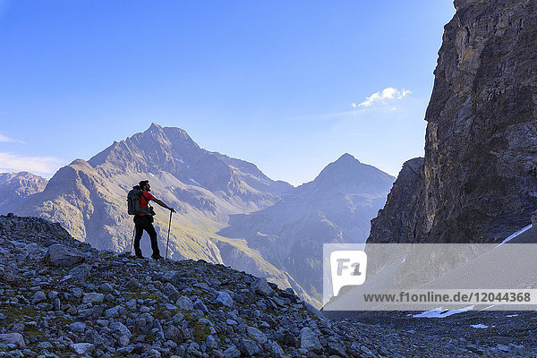 Hiker on the trail to Lej Lagrev  St. Moritz  Upper Engadine  Canton of Graubunden  Switzerland  Europe