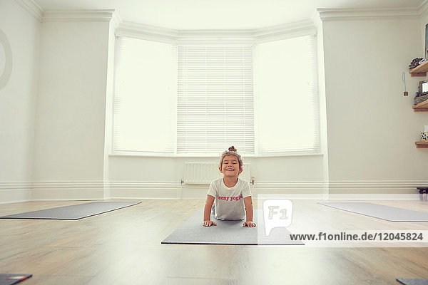 Young girl in yoga studio  in yoga position