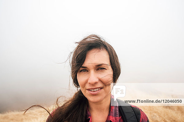 Portrait of woman in misty field looking at camera smiling Fairfax California USA North America