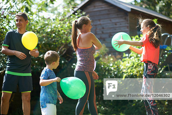 Familie spielt mit Luftballons im Garten