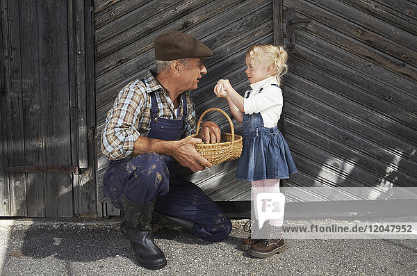 Farmer and Girl with Basket of Eggs