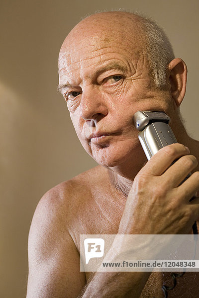 Man Shaving with Electric Razor