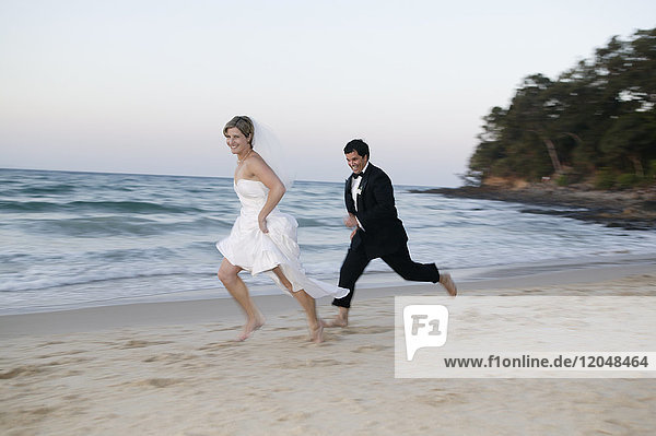 Groom and Bride Running on Beach  Noosa Beach  Australia