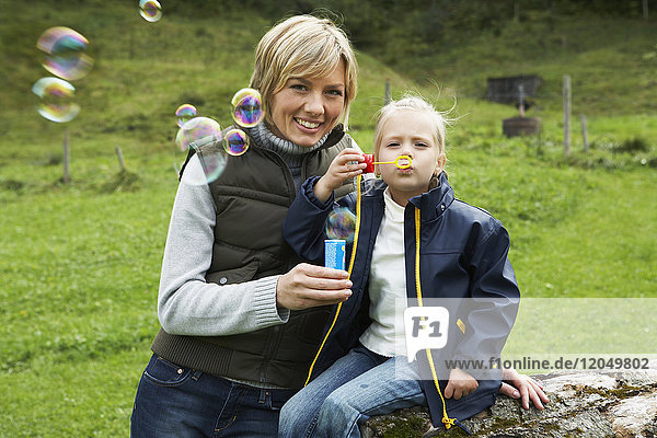 Mother and Daughter Blowing Bubbles