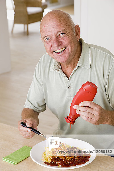 Man Putting Ketchup of Food