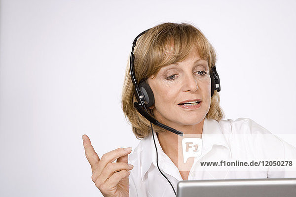 Businesswoman with Headset and Laptop Computer