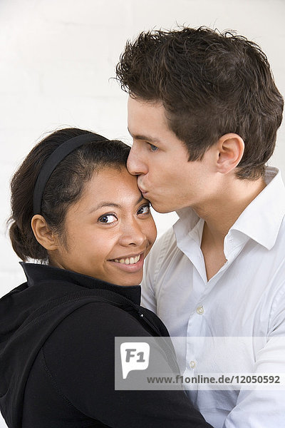 Man Kissing Woman on Forehead