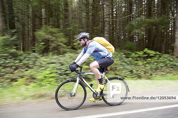 Cyclist Riding Through Pacific Rim National Park; Vancouver  British Columbia  Canada