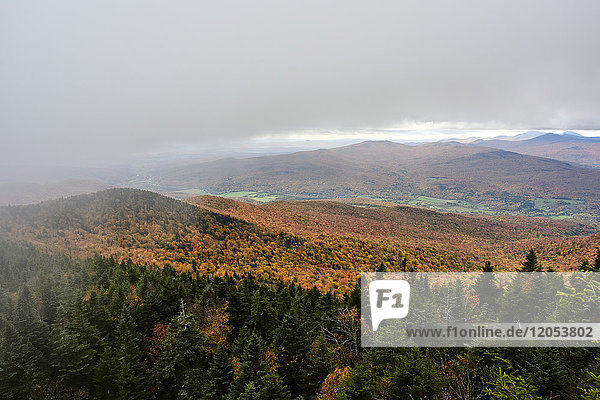 Rain Falls From Heavy Clouds Over An Autumn Coloured Forest In The Mountains; Dunham  Quebec  Canada