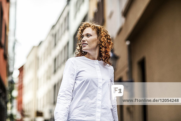 Portrait of redheaded young woman outdoors