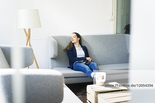 Businesswoman sitting on couch relaxing