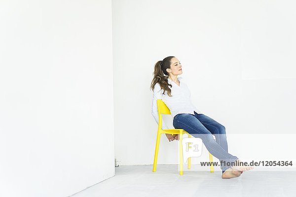 Woman sitting on a yellow chair