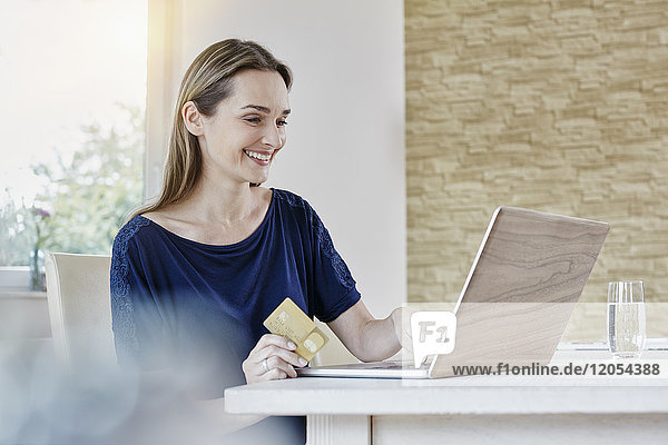 Happy woman at home shopping online