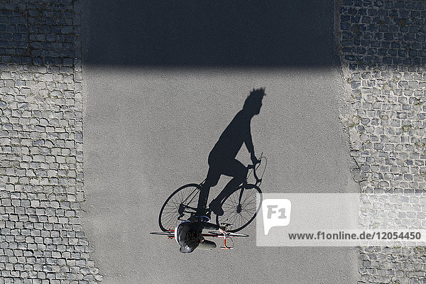 Top view of man riding bicycle