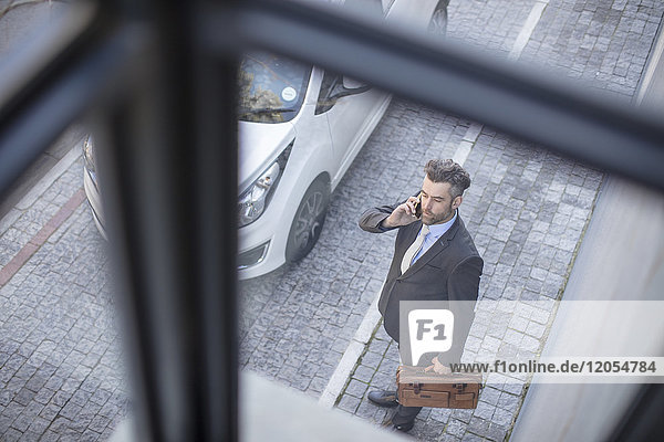 Businessman outside talking on his cell phone