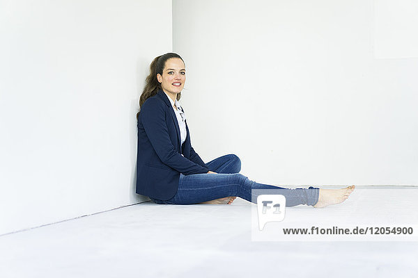 Portrait of businesswoman sitting on the floor