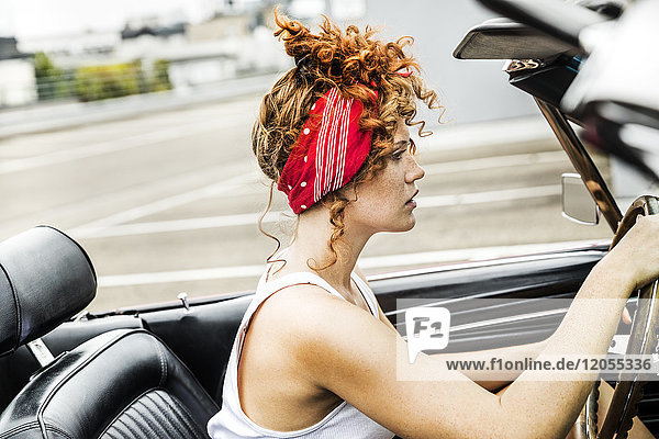 Redheaded woman in sports car