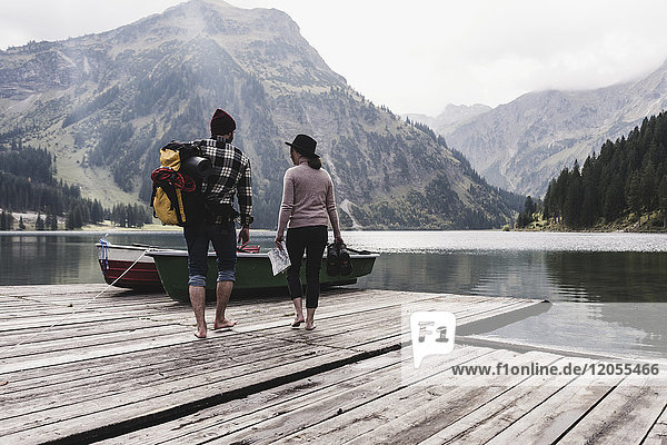 Austria  Tyrol  Alps  couple walking on jetty at mountain lake